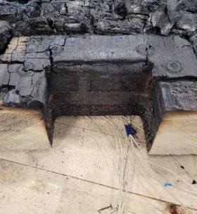 Charred mass timber test assembly following a fire experiment.
