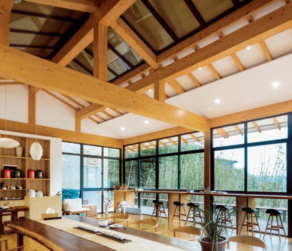 Dining room with wooden beans and furniture at a villa resort in Hui Xin, China