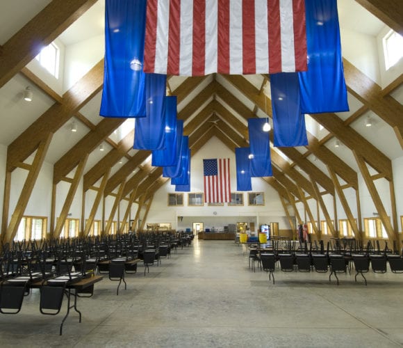 United States flags in a conference room with wooden beams