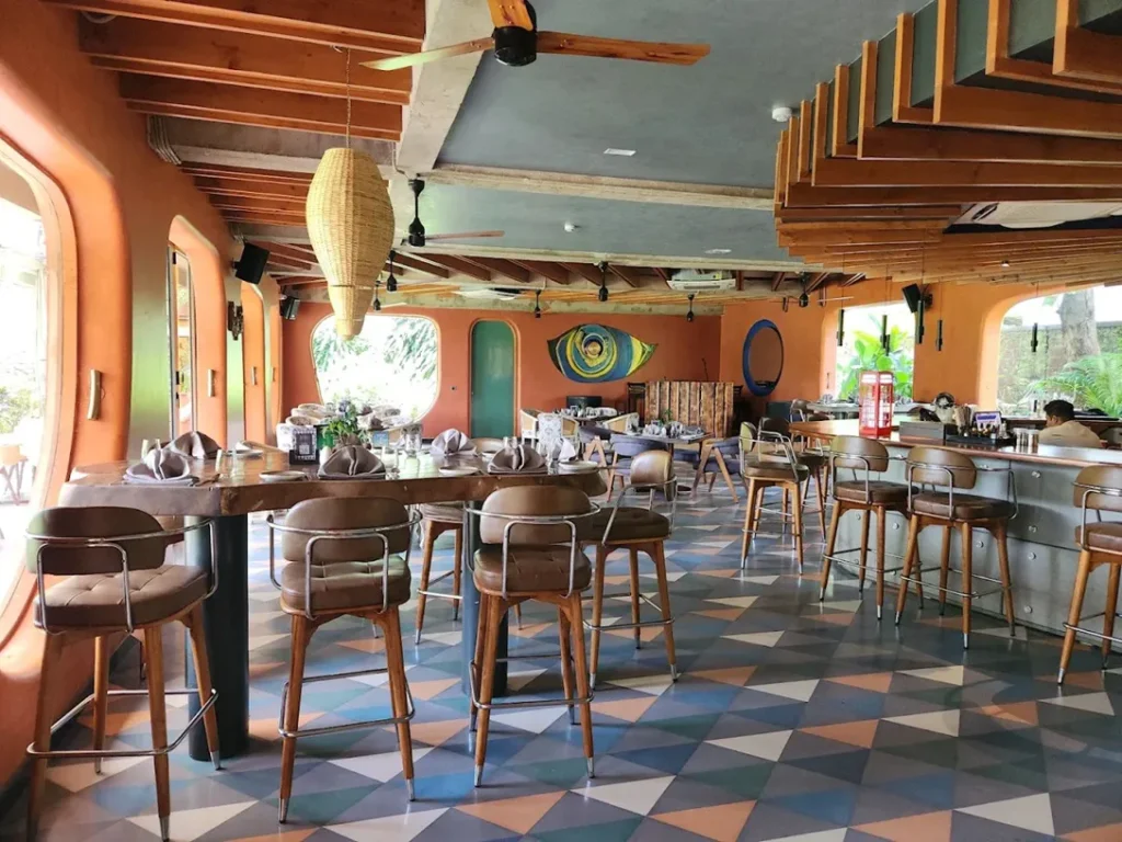 Restaurant interior showcasing exposed wood ceiling beams, suspended timber features, wood furniture and wood finishes throughout the dining space.