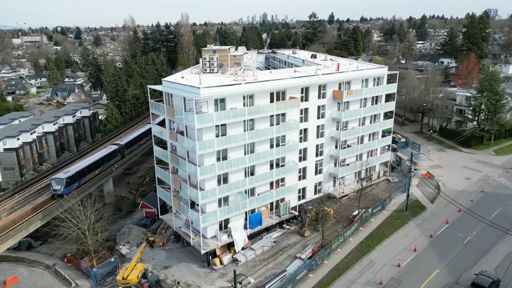 Eight-storey mass timber residential building near a transit line, demonstrating the use of wood construction in urban multi-family housing.