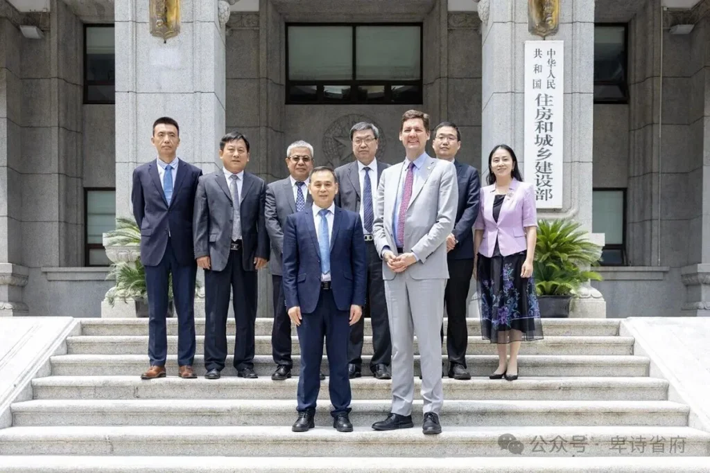 Premier David Eby and delegation members pose with officials on the steps outside China’s Ministry of Housing and Urban-Rural Development building during an official visit.